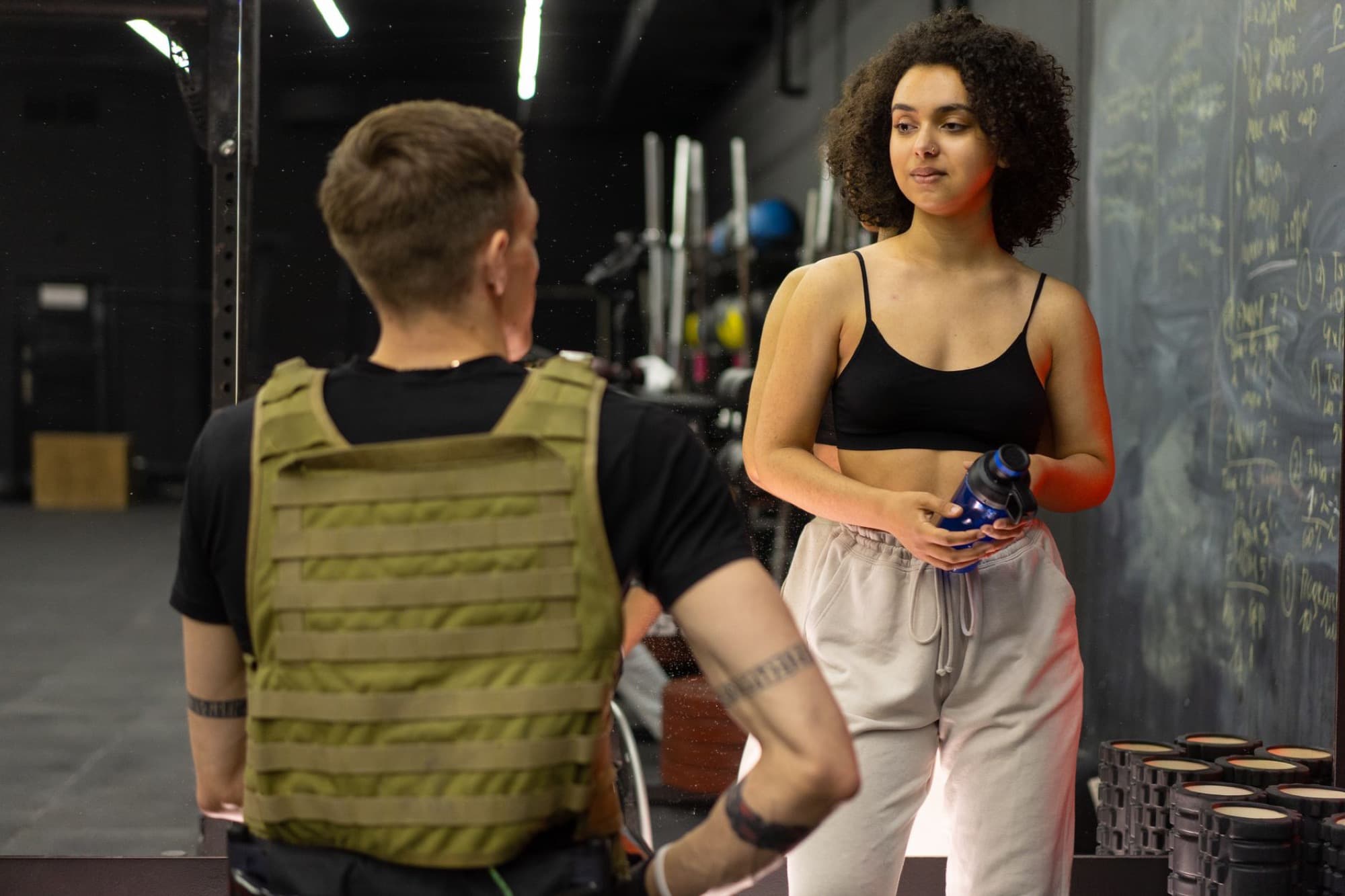 Coach working with a client in a gym